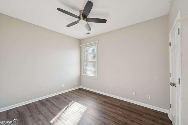 unfurnished room with ceiling fan and dark hardwood / wood-style flooring