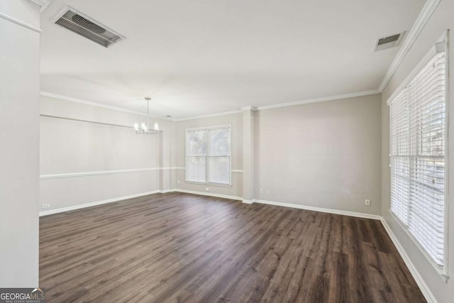 unfurnished room with crown molding, dark wood-type flooring, and a notable chandelier