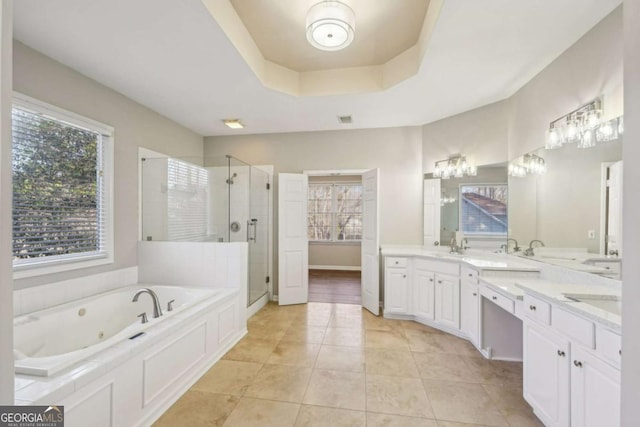 bathroom featuring shower with separate bathtub, a raised ceiling, tile patterned flooring, and vanity