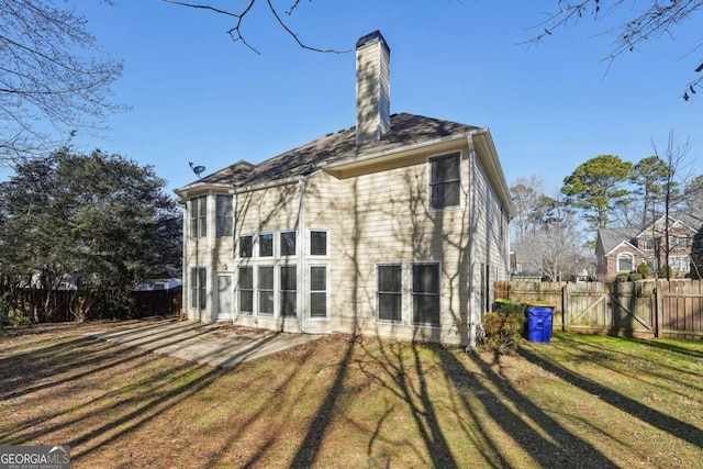 back of house featuring a patio area and a yard