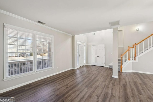 entryway with crown molding, dark wood-type flooring, and decorative columns