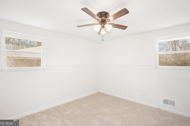 empty room featuring carpet flooring and ceiling fan