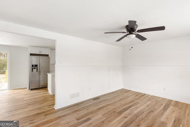 unfurnished room featuring light hardwood / wood-style flooring and ceiling fan