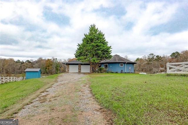 ranch-style home with a garage and a front lawn