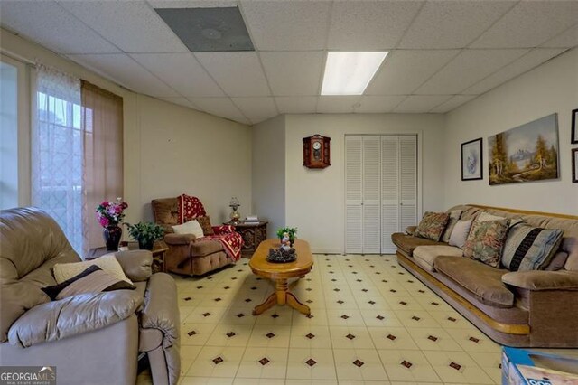 living room featuring a drop ceiling