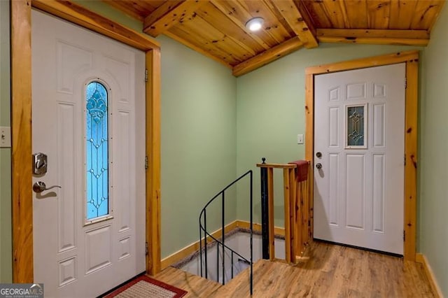 entryway featuring lofted ceiling with beams, wooden ceiling, and light hardwood / wood-style floors