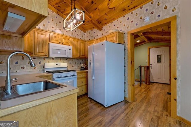 kitchen with pendant lighting, sink, vaulted ceiling with beams, wooden ceiling, and white appliances