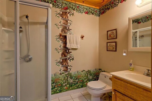 bathroom featuring vanity, a shower with door, tile patterned floors, and toilet