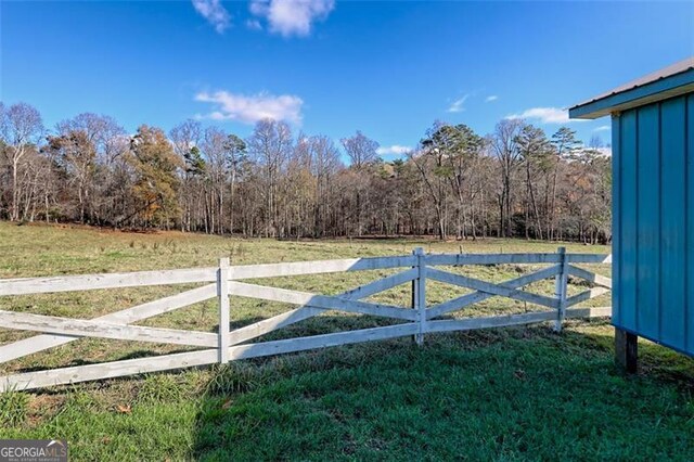 view of gate featuring a yard