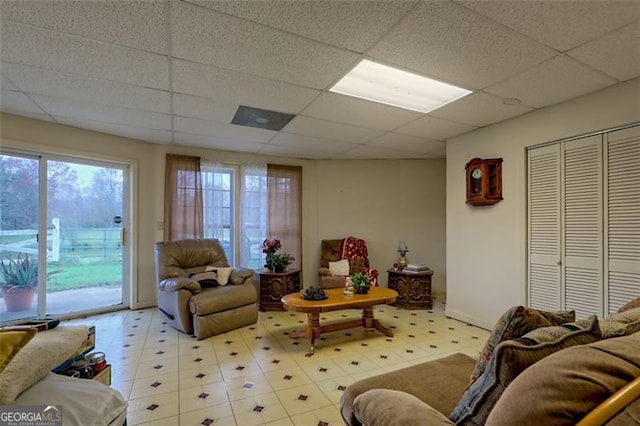 living room featuring a paneled ceiling