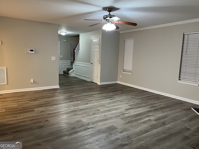 spare room with ceiling fan, dark wood-type flooring, and ornamental molding