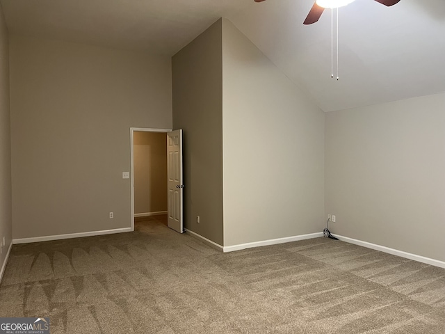 spare room with ceiling fan, carpet, and high vaulted ceiling