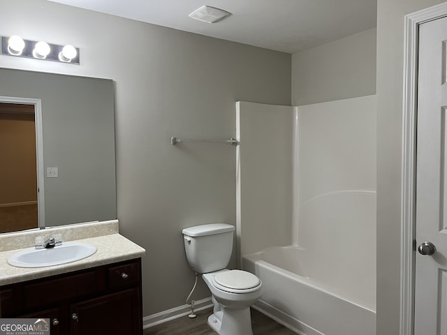 full bathroom featuring tub / shower combination, wood-type flooring, toilet, and vanity