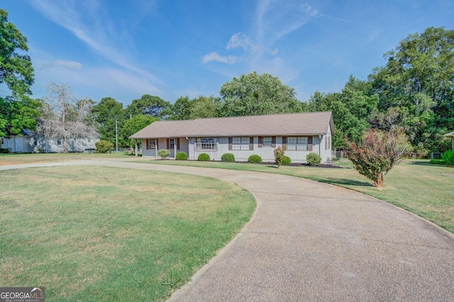 ranch-style home with a front lawn