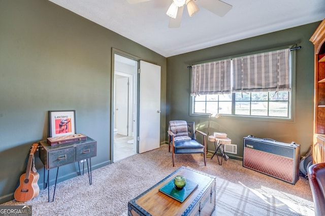 sitting room featuring ceiling fan and light carpet