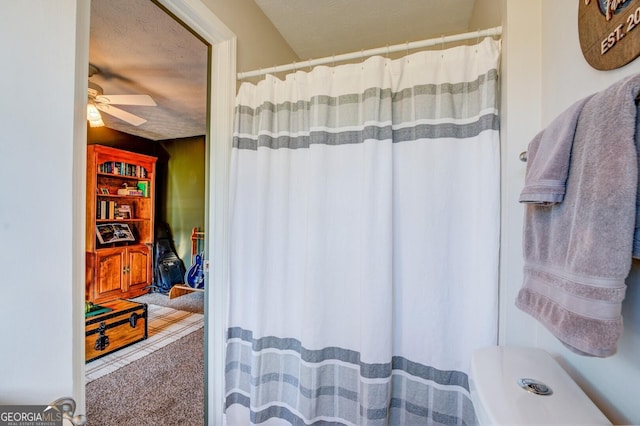 bathroom with a textured ceiling and ceiling fan