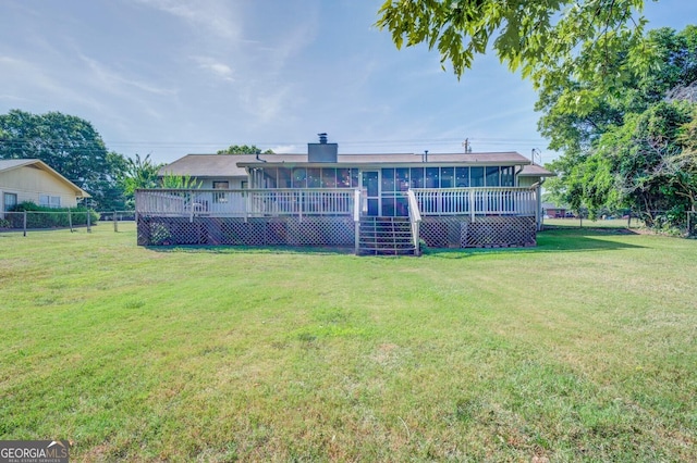 view of yard featuring a sunroom and a wooden deck