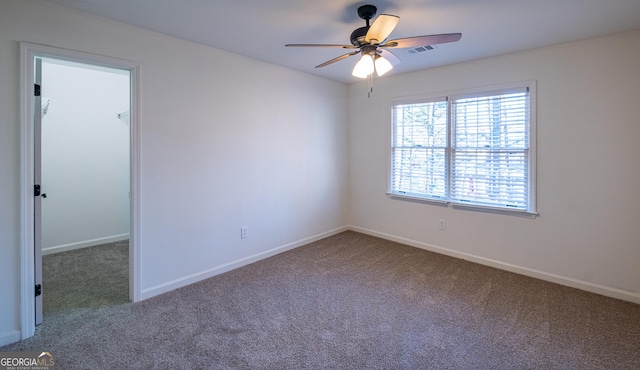 carpeted office space featuring ceiling fan