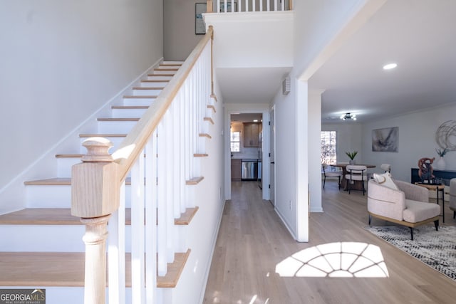 living room with light hardwood / wood-style flooring and crown molding