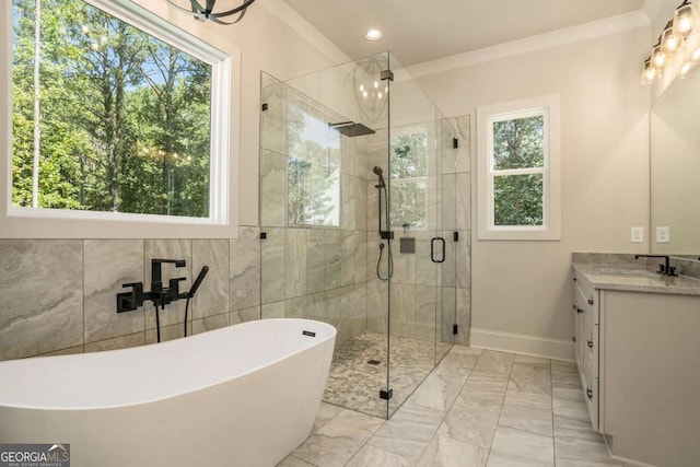 bathroom featuring vanity, plenty of natural light, marble finish floor, and a stall shower