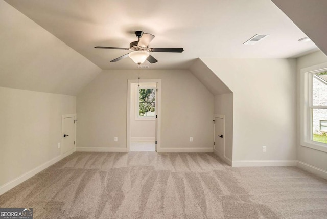 bonus room with ceiling fan, light colored carpet, and lofted ceiling