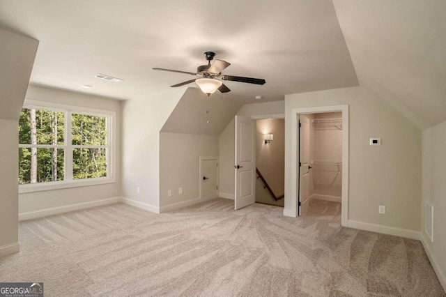 additional living space with light carpet, ceiling fan, and lofted ceiling