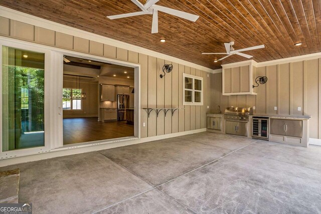 view of patio featuring area for grilling, sink, wine cooler, and ceiling fan