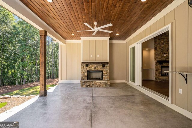 view of patio / terrace with ceiling fan and an outdoor stone fireplace