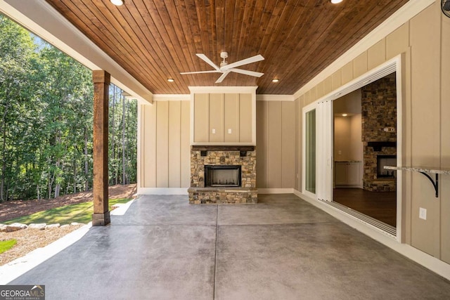 view of patio / terrace featuring a ceiling fan and an outdoor stone fireplace