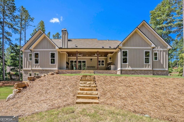 back of house featuring a yard and ceiling fan