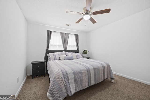 bedroom featuring ceiling fan, carpet floors, and a textured ceiling