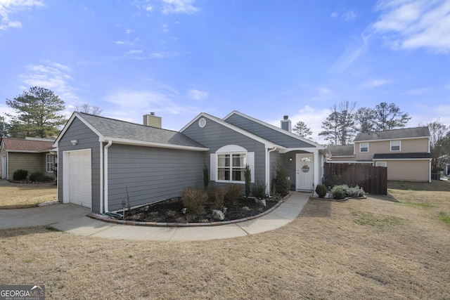 view of front of property with a garage and a front lawn