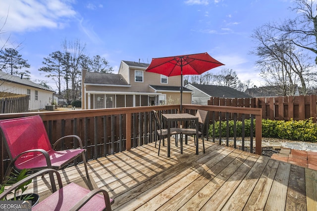 deck with a sunroom