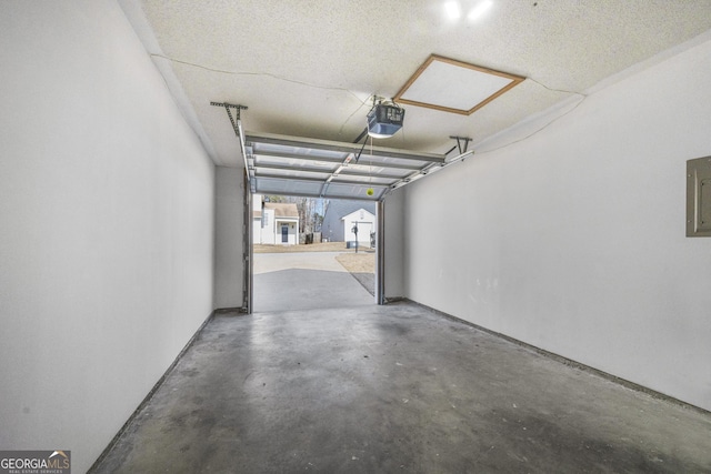 garage with a garage door opener and electric panel