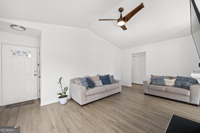 living room with vaulted ceiling, ceiling fan, and hardwood / wood-style floors