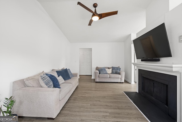 living room with hardwood / wood-style floors and ceiling fan