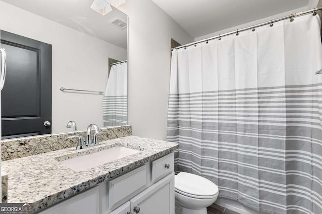 bathroom with toilet and vanity