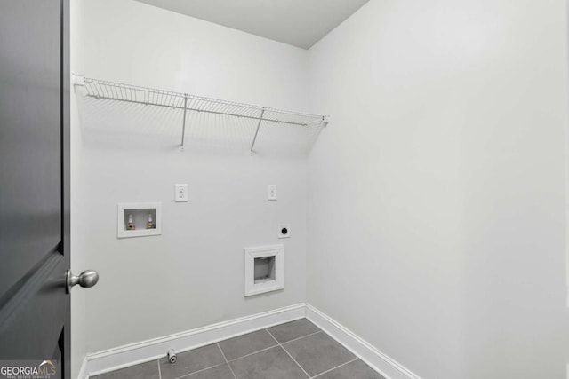 laundry room featuring hookup for a washing machine, electric dryer hookup, and dark tile patterned floors