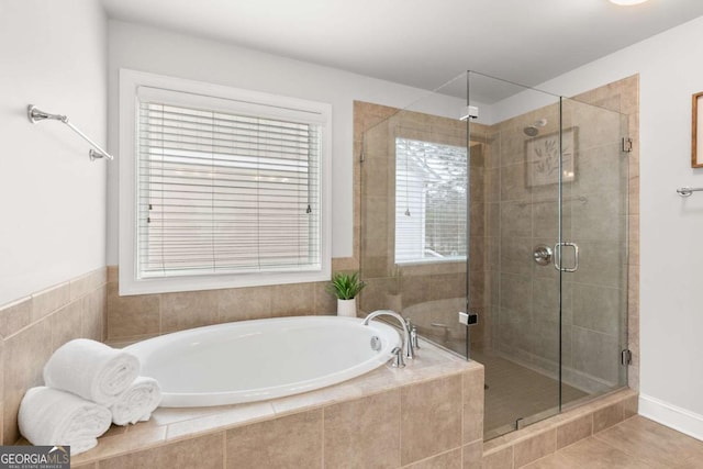 bathroom featuring tile patterned floors, separate shower and tub, and a healthy amount of sunlight