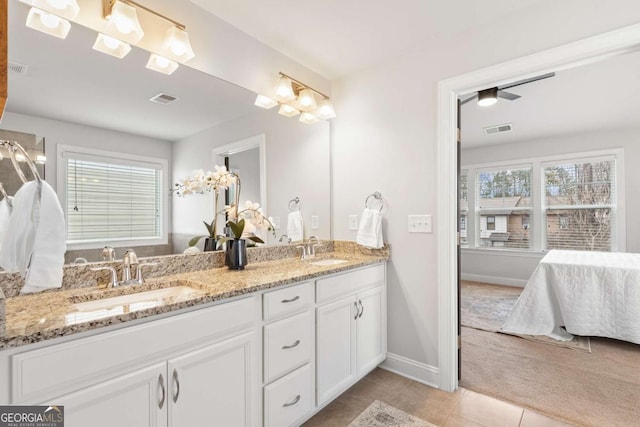 bathroom with vanity, a wealth of natural light, and tile patterned floors