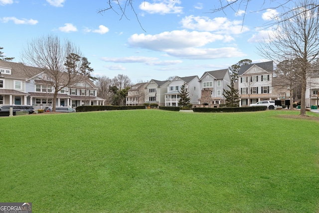 view of home's community featuring a lawn