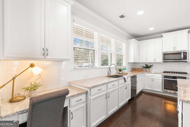 kitchen with sink, white cabinets, dark hardwood / wood-style floors, and stainless steel appliances