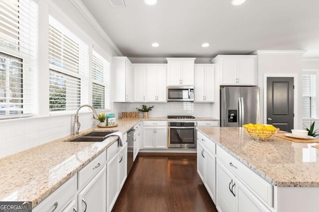 kitchen featuring sink, light stone counters, and appliances with stainless steel finishes