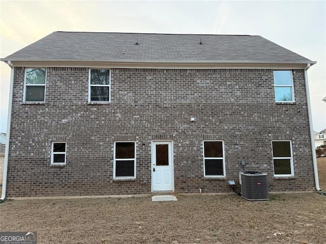 view of front facade with central AC unit and a front lawn