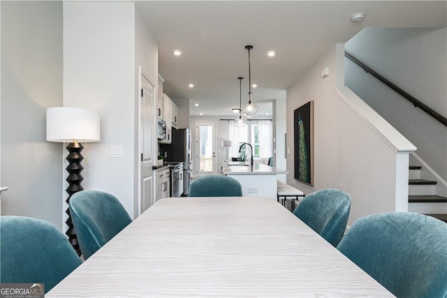 dining room with stairs and recessed lighting