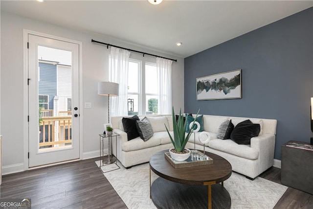 living room with baseboards and wood finished floors