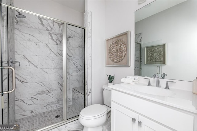 full bath with toilet, marble finish floor, a marble finish shower, and vanity