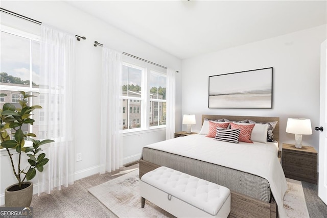 bedroom with carpet floors, multiple windows, and baseboards