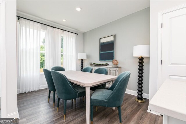 dining space featuring baseboards, dark wood-type flooring, and recessed lighting