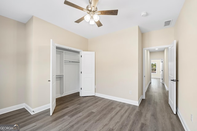 unfurnished bedroom with hardwood / wood-style flooring, a closet, and ceiling fan